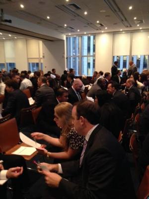 Crowded room of people sitting together talking