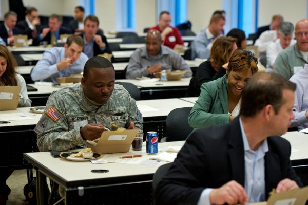 Attendees sitting at tables eating