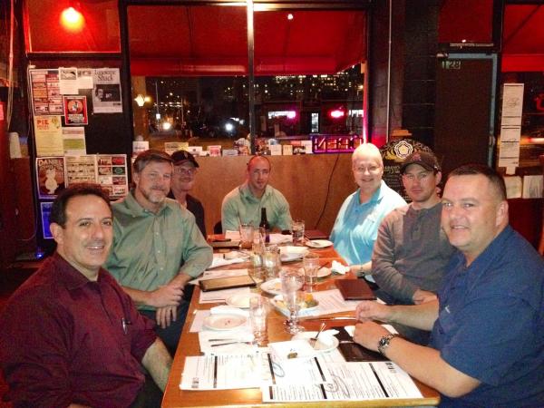 7 of the attendees pose for photo at their table