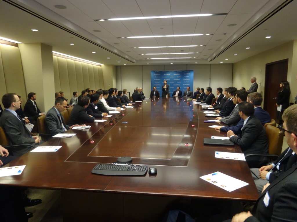 attendees sitting at large conference table listening to speaker