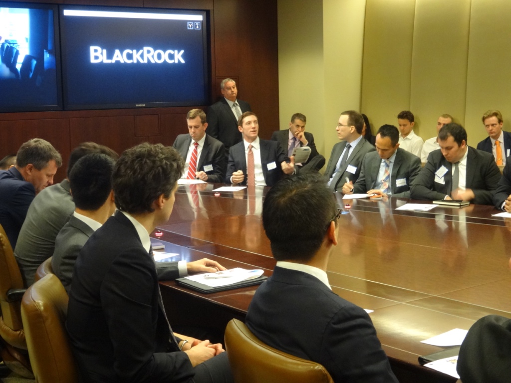 Attendees sitting around large conference table 